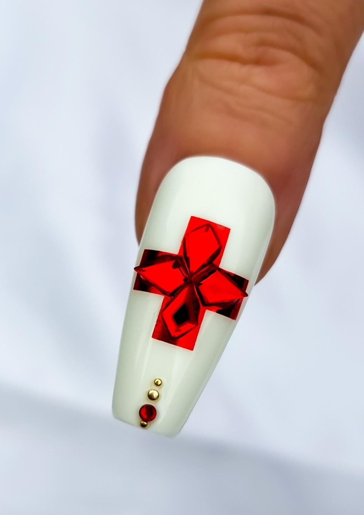 White thumb nail with red cross from Kingdom of Tonga flag with red crystals inside.