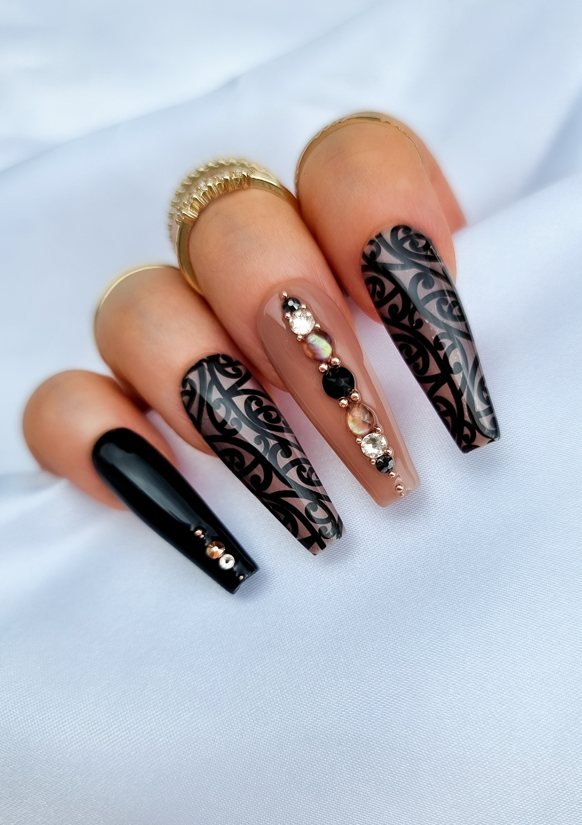 Black and nude nails with Maori kowhaiwhai design and Swarovski crystals