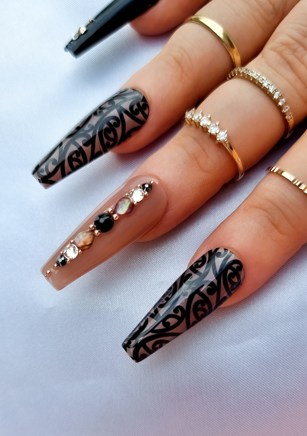 Black and nude nails with Maori kowhaiwhai design and Swarovski crystals