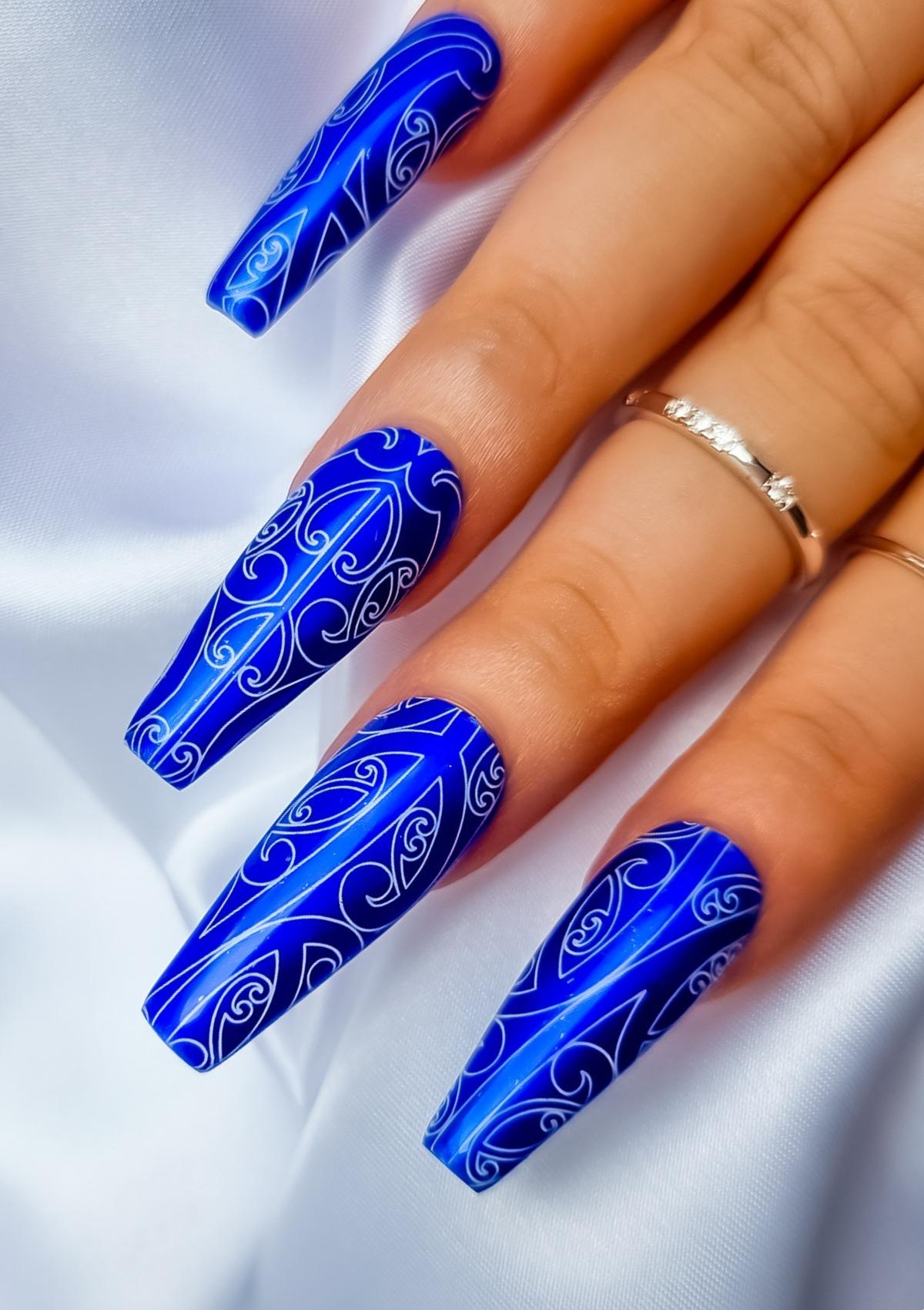 Dark blue nails with white Maori designs 