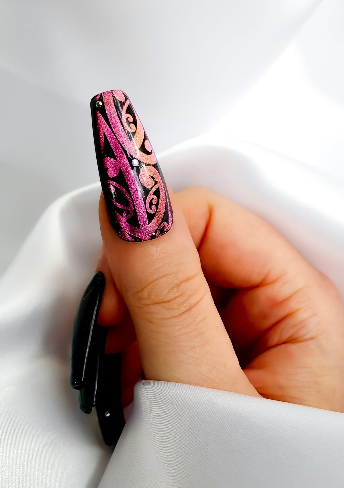 Purple thumb nail with Black Maori Nail Foil design and Swarovski crystals